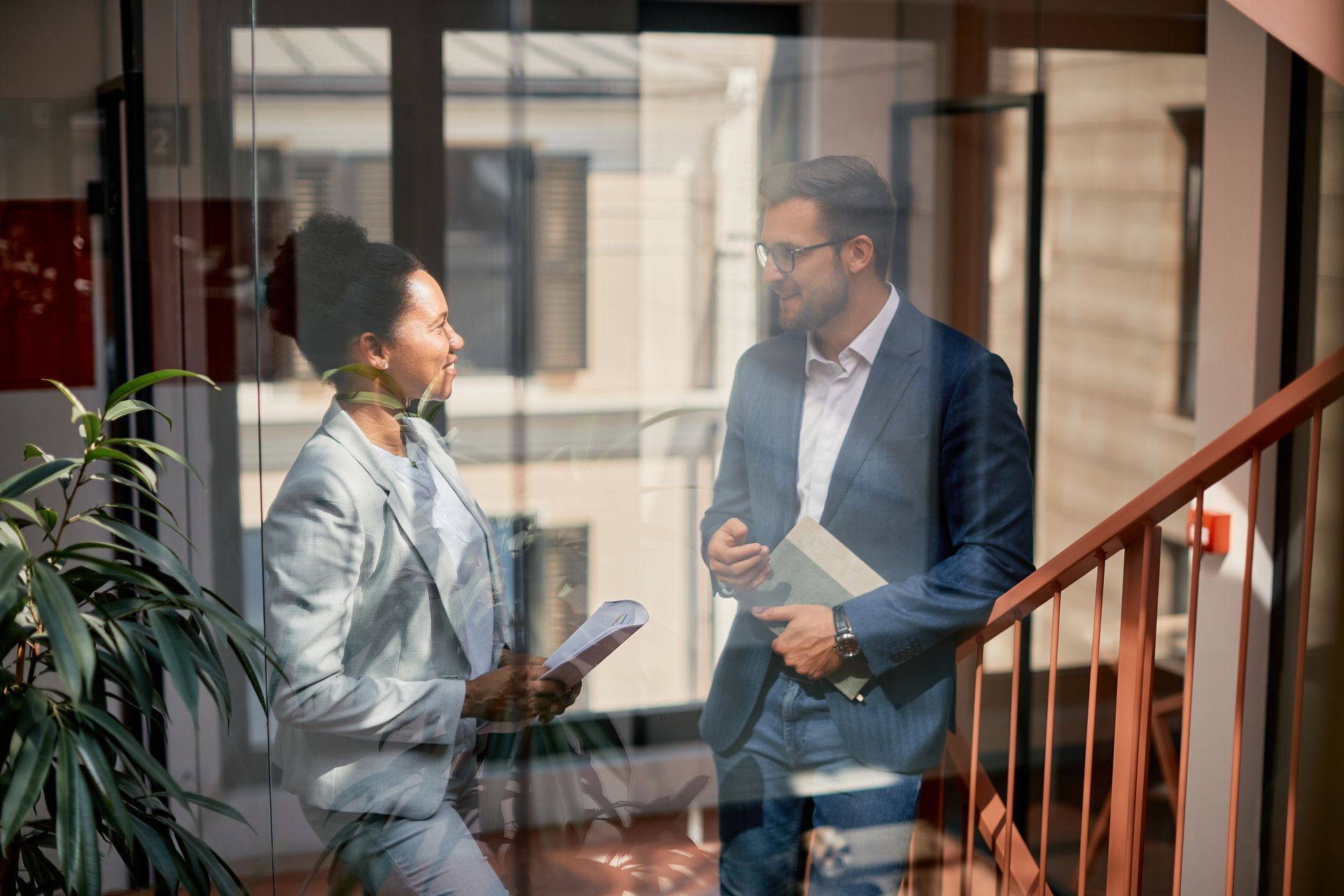 A man and a woman are standing next to each other in a room.