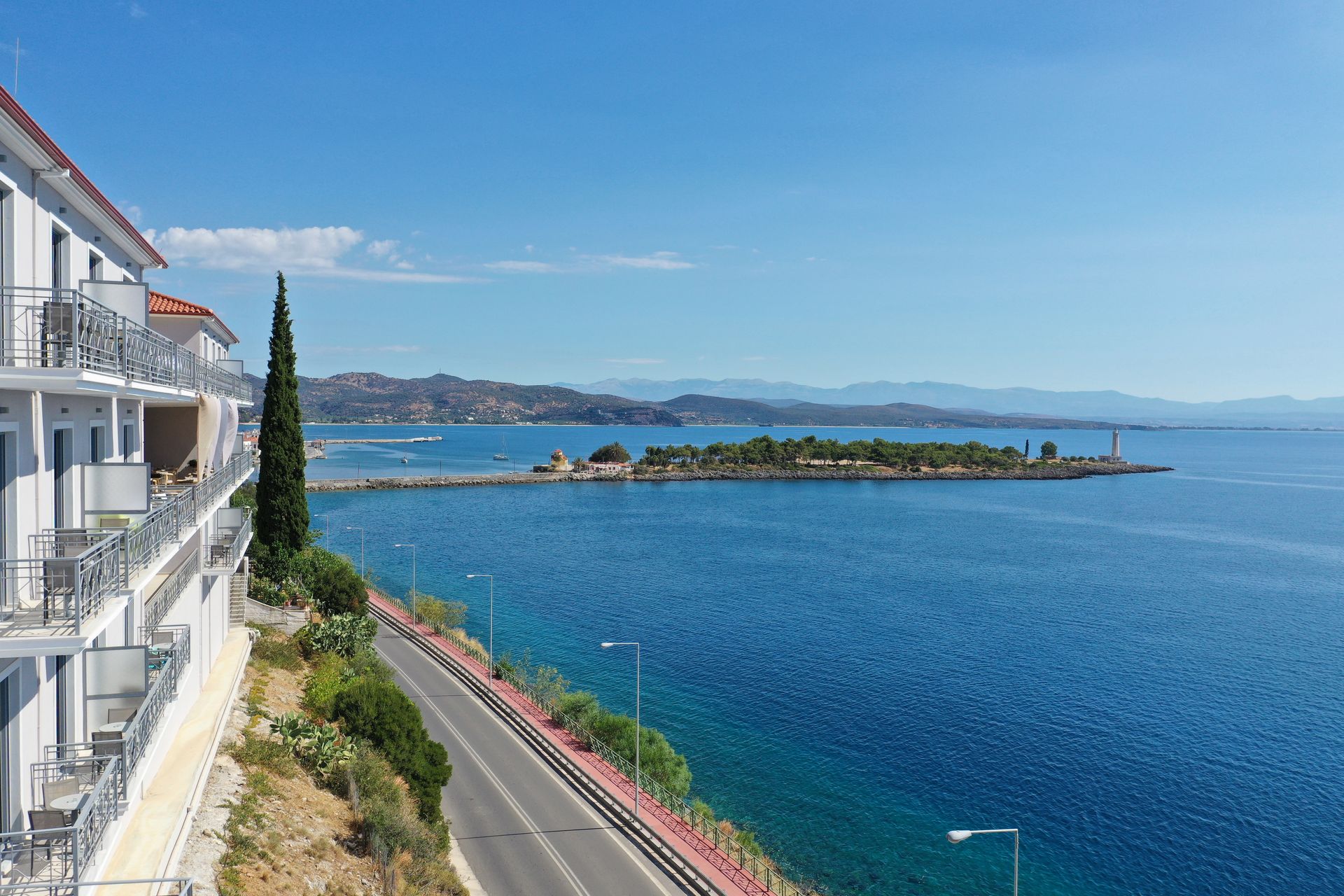 An aerial view of a building overlooking a body of water.