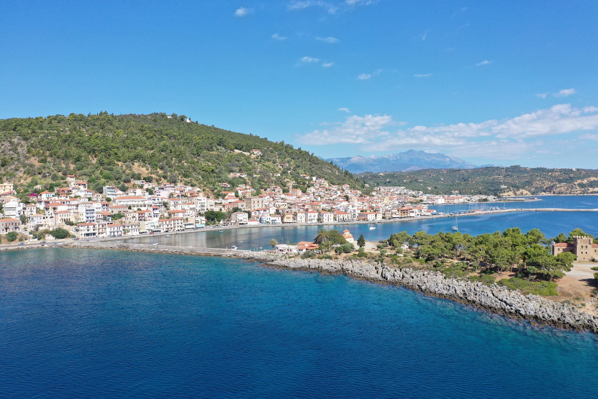 An aerial view of a small town next to a body of water.
