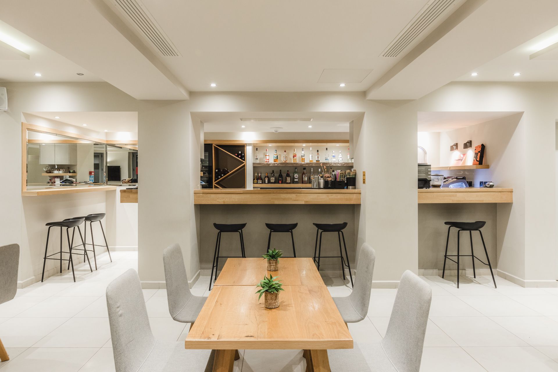 A dining room with a table and chairs and a bar.