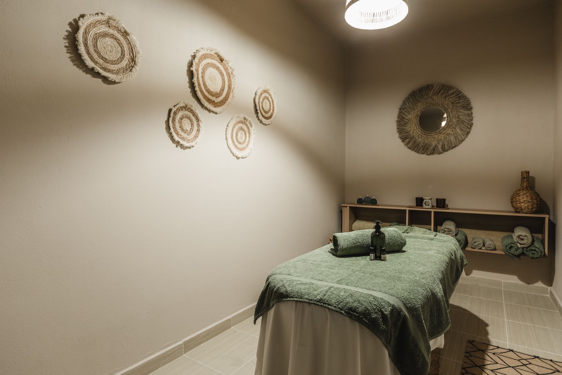 There is a massage table in the middle of the room.