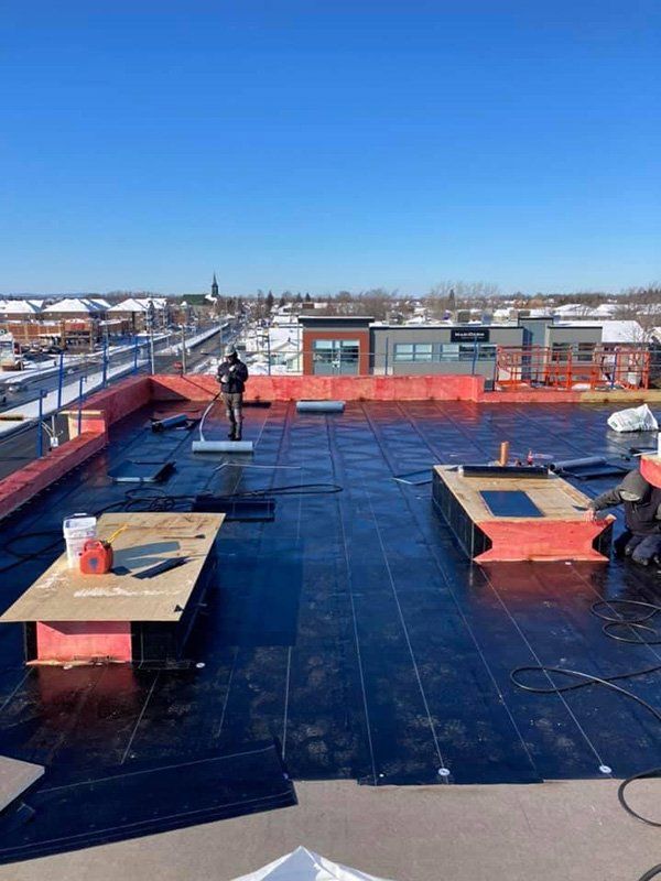 Un homme se tient debout sur le toit d'un immeuble.