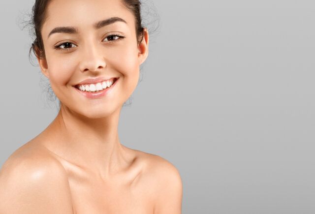 A close up of a woman 's face with a smile on her face.