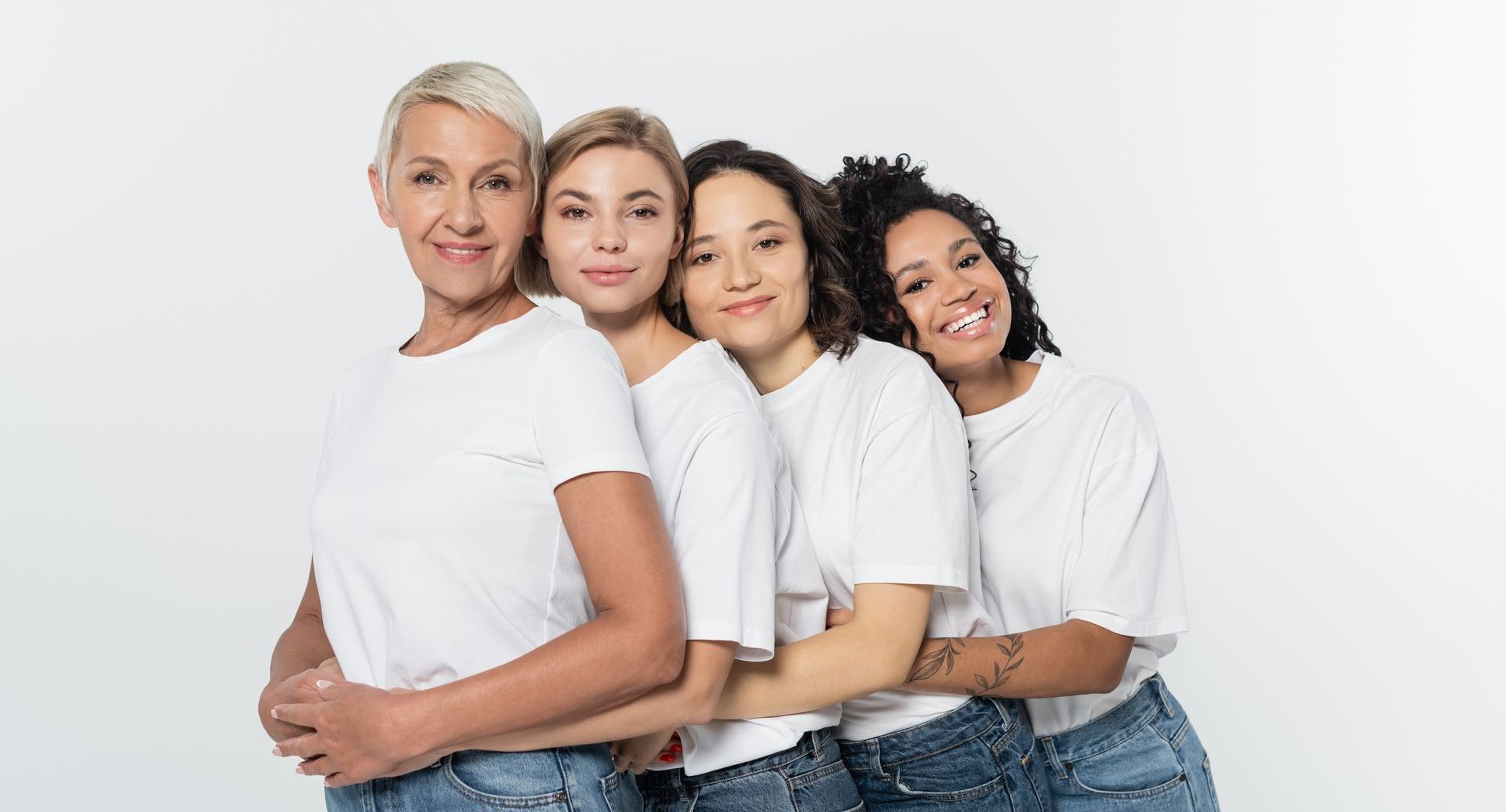 A group of women are hugging each other on a white background.