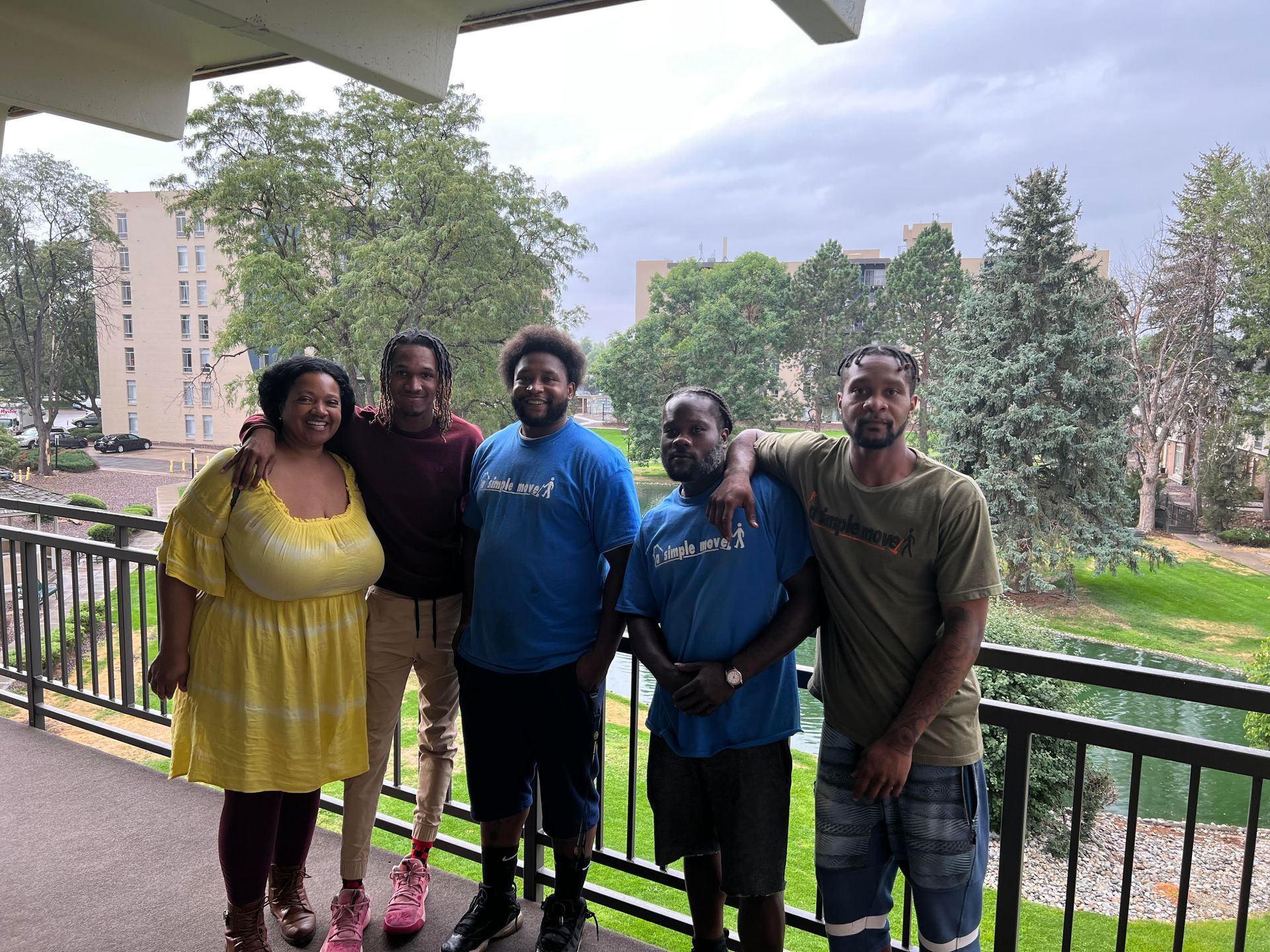 A group of people are posing for a picture on a balcony.
