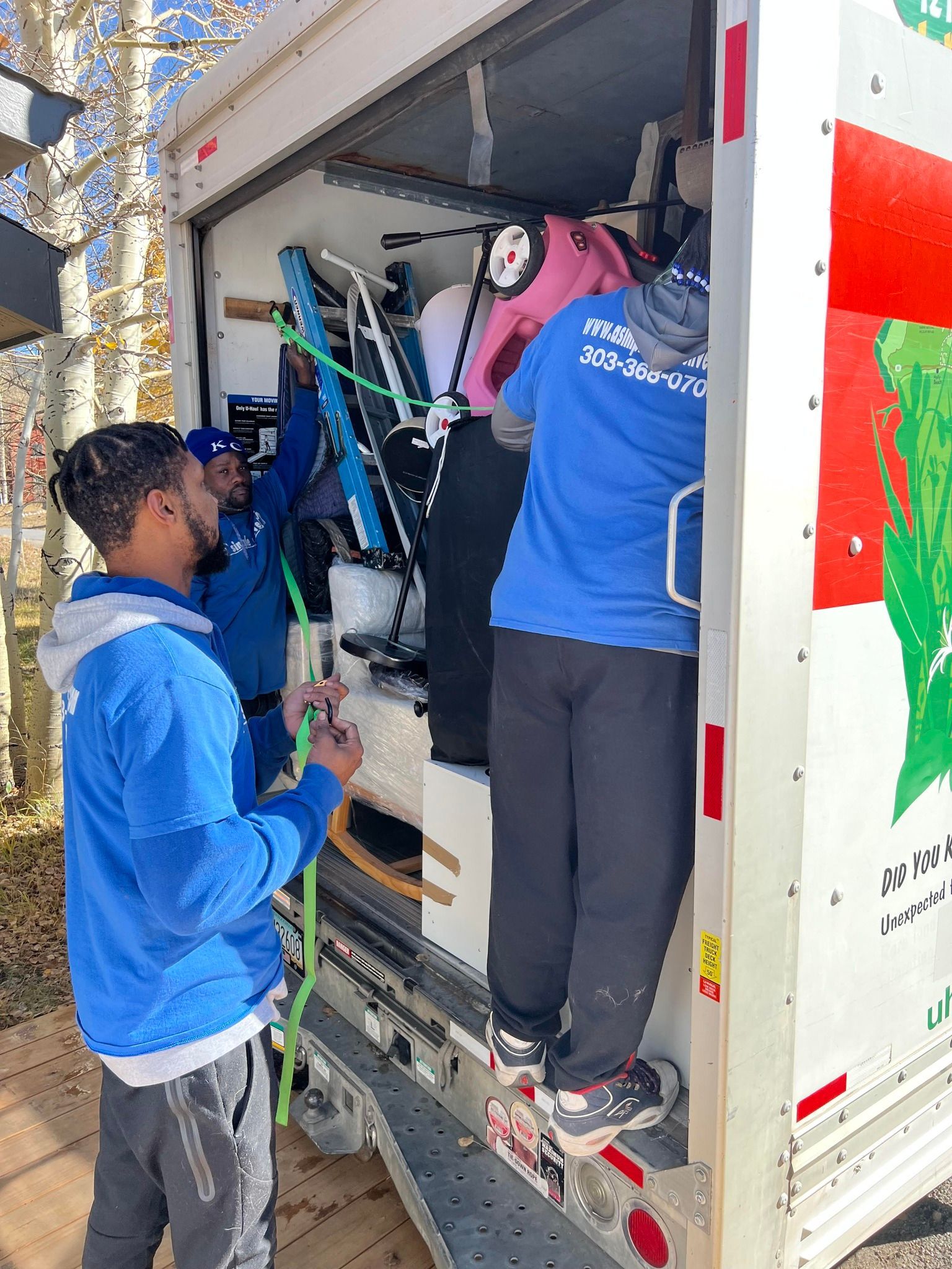 A group of men are loading furniture into a moving truck.