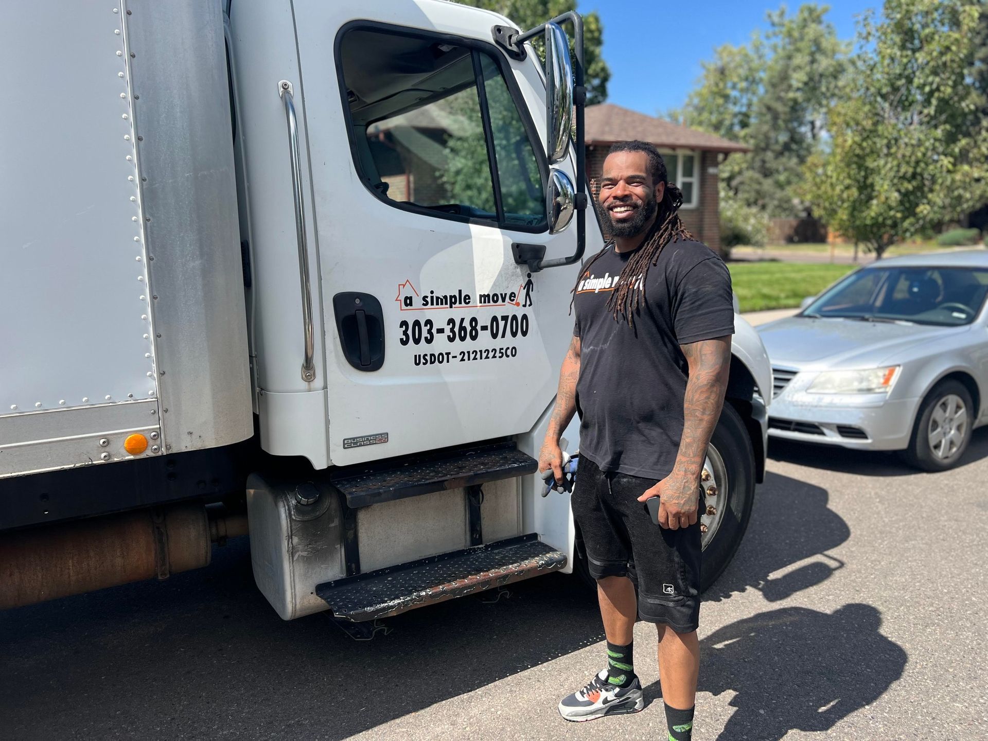 A man is standing in front of a white truck.