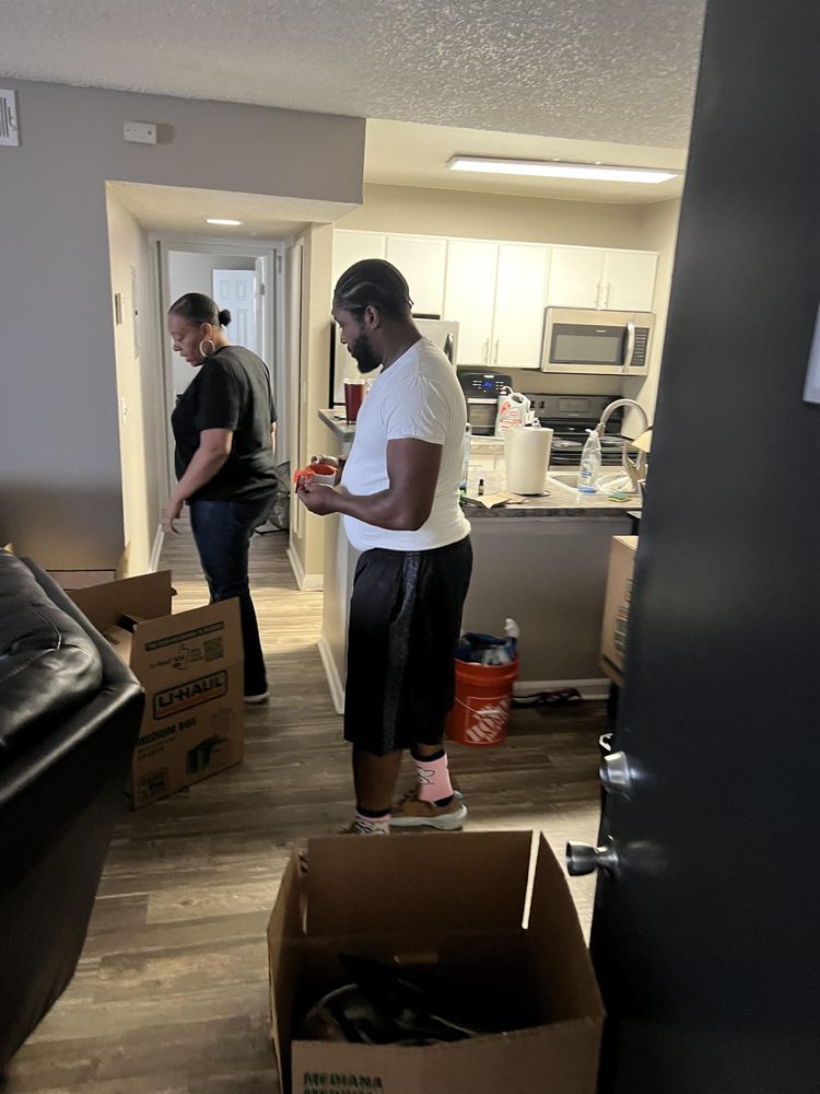 A man and a woman are moving into a house.