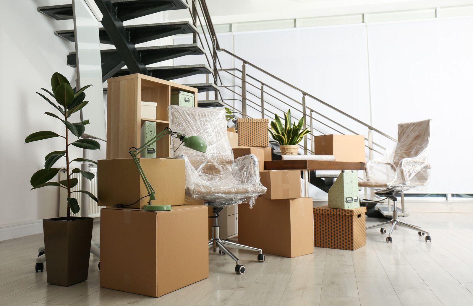 A room filled with lots of cardboard boxes and furniture.