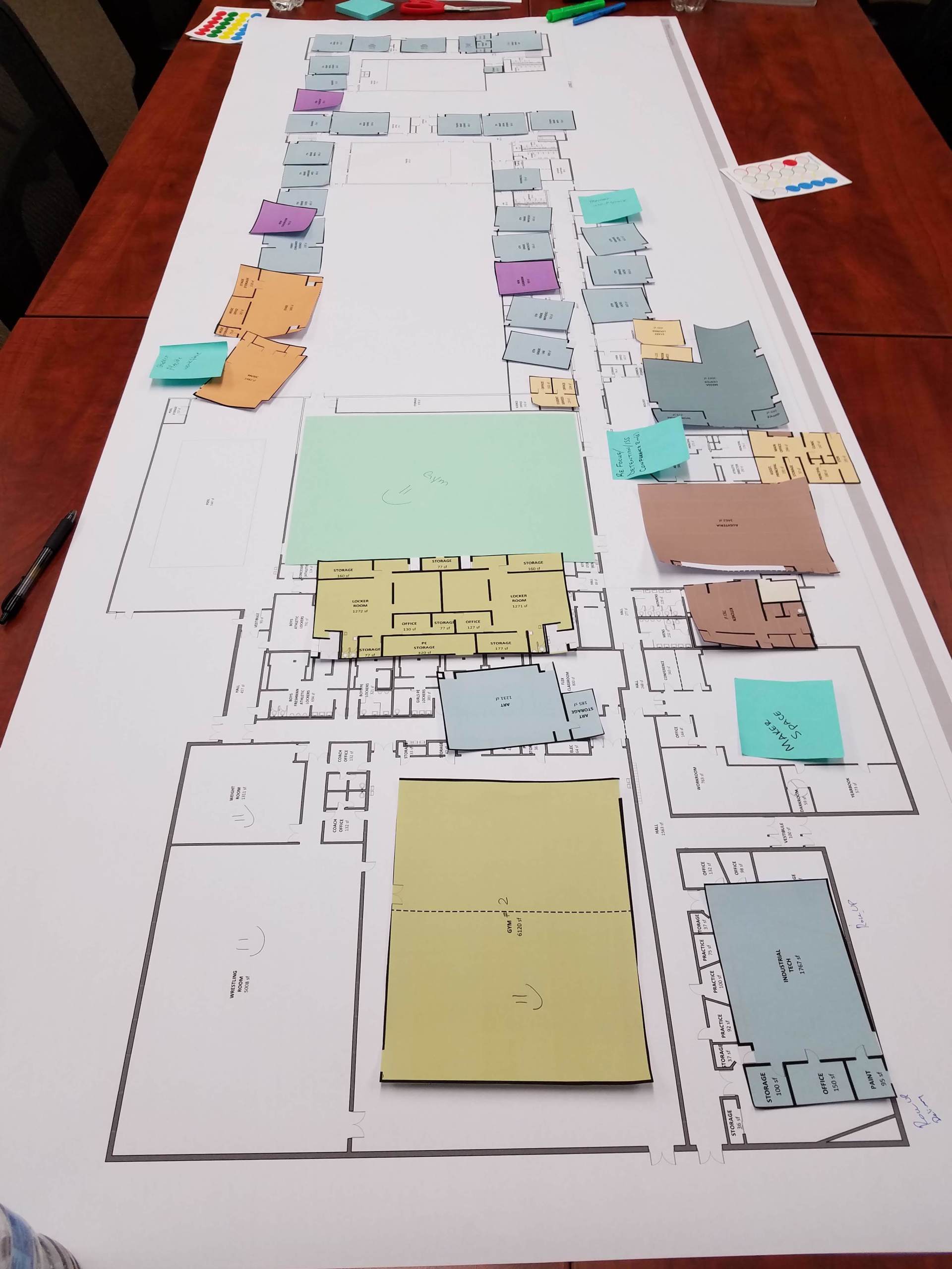 A floor plan of a building with sticky notes on it