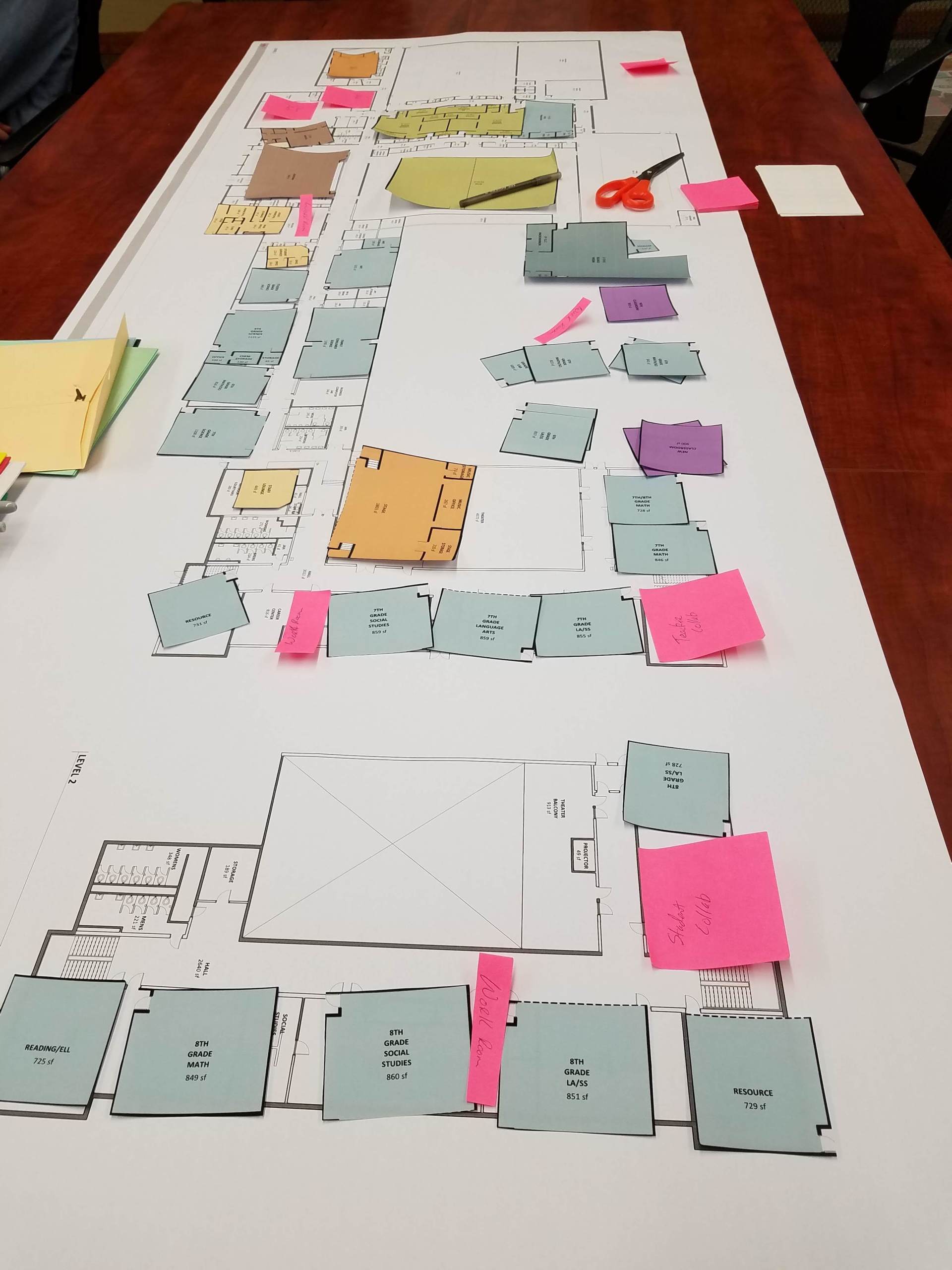 A floor plan of a building with sticky notes on it