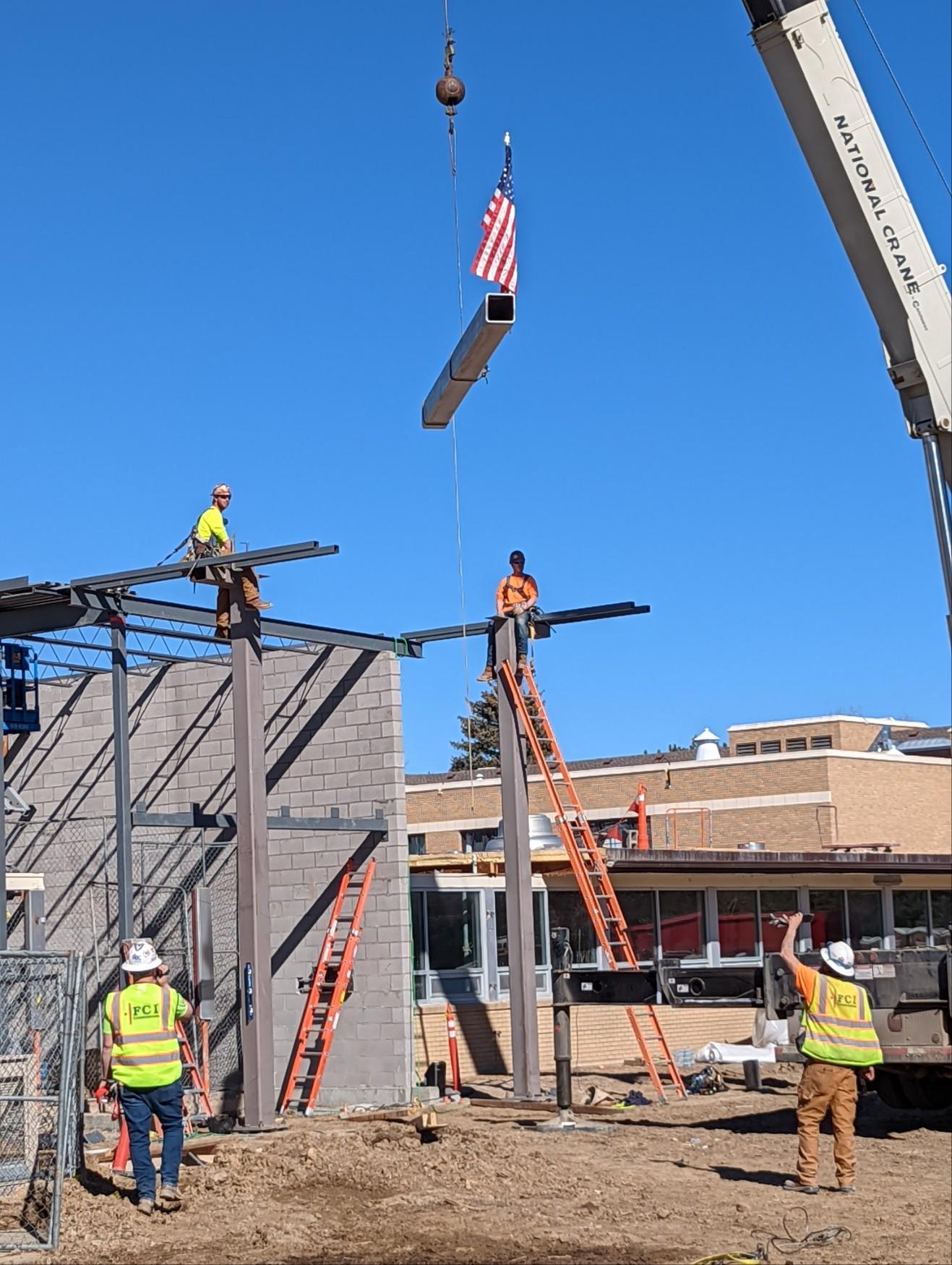 A group of construction workers are working on a building.