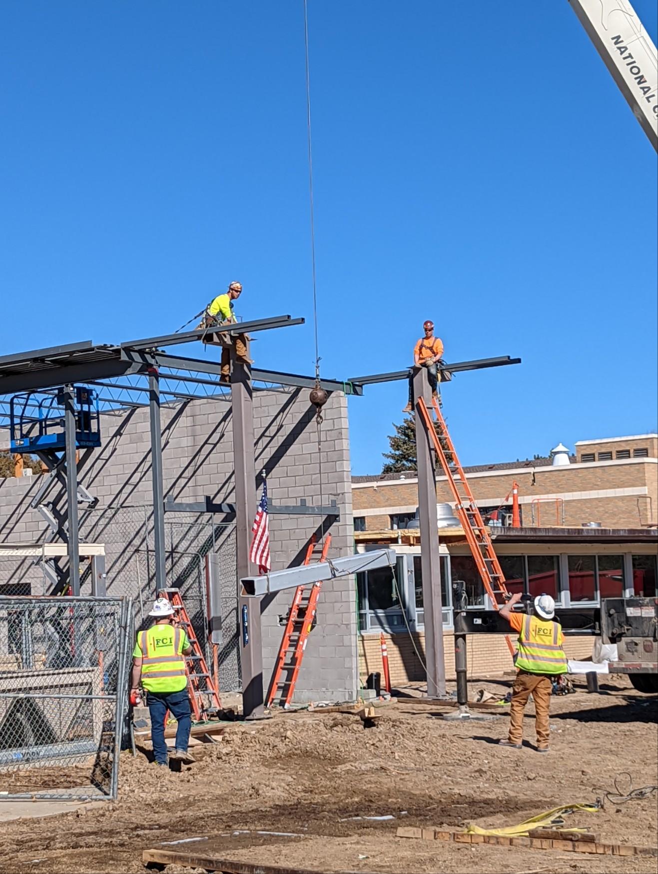 A group of construction workers are working on a building