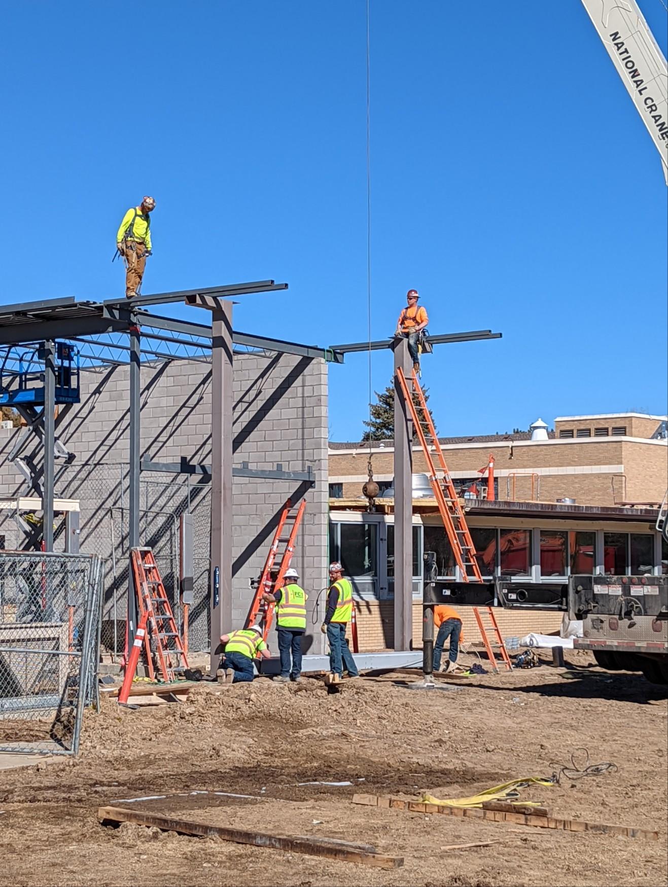 A group of construction workers are working on a building