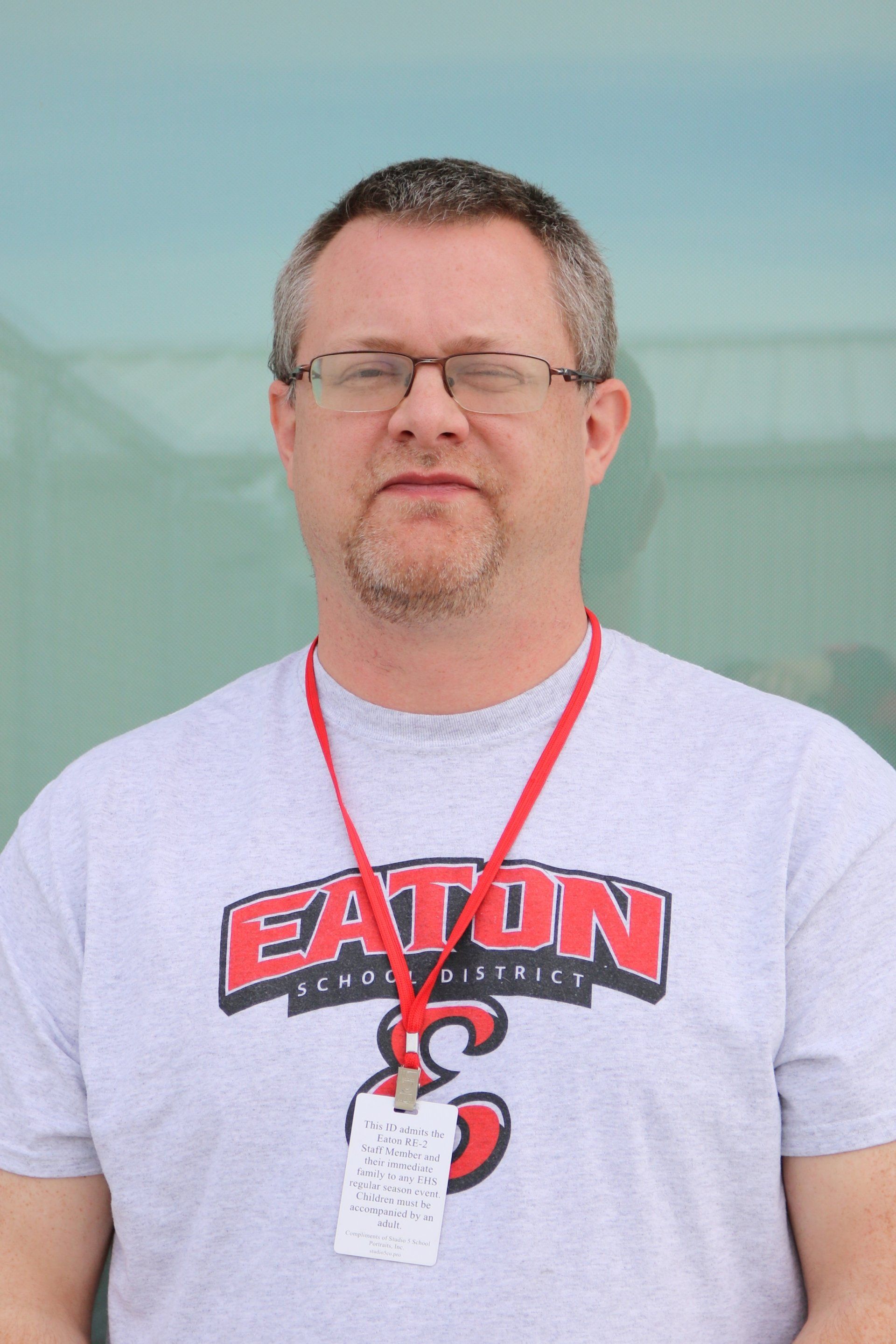 A man wearing glasses and a eaton shirt