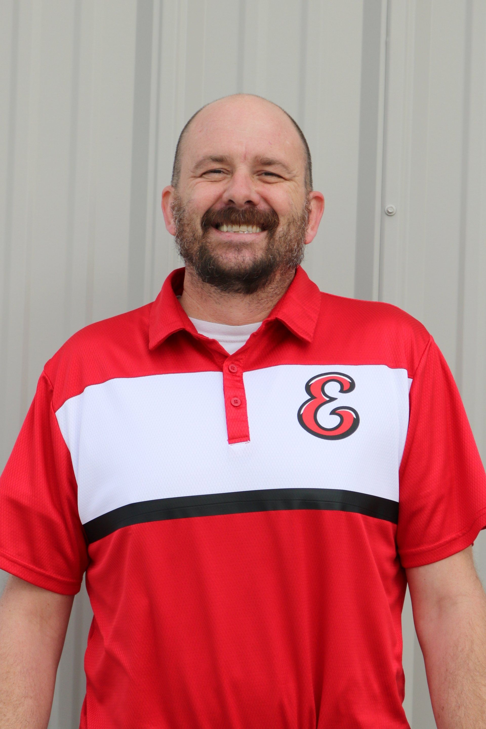 A man wearing a red and white shirt with the number 18 on it