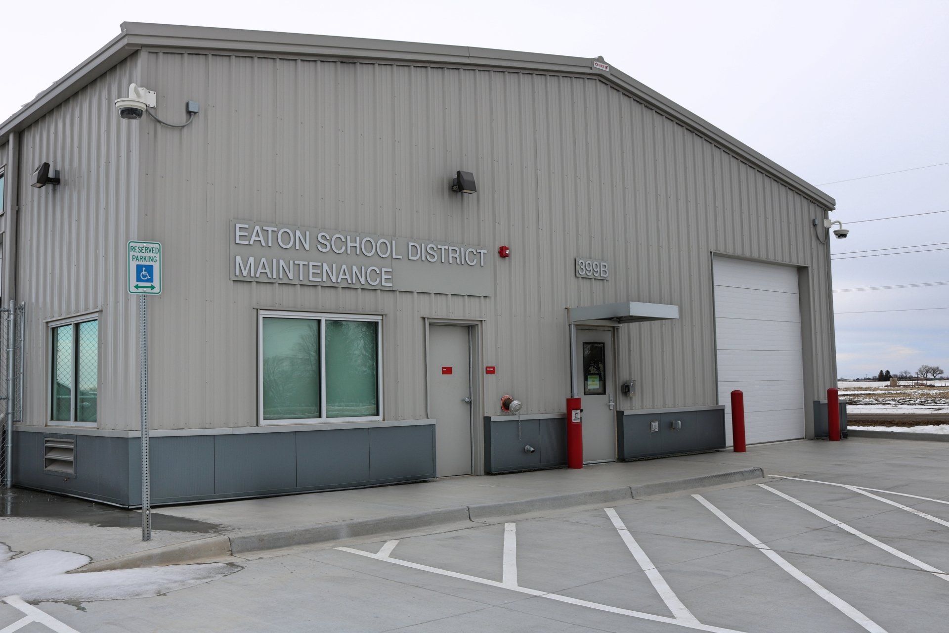 A large building with a parking lot in front of it