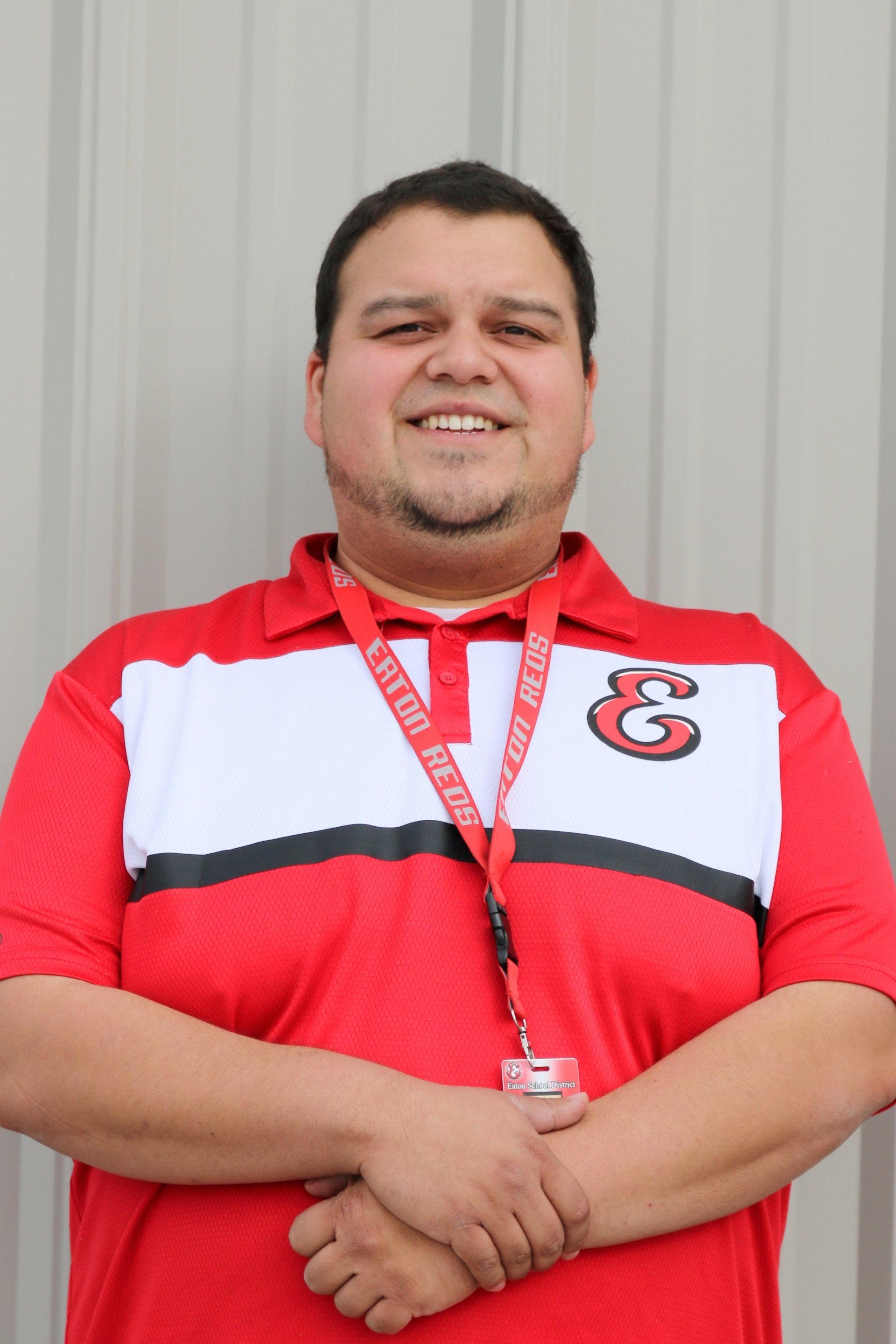 A man wearing a red shirt with the letter g on it