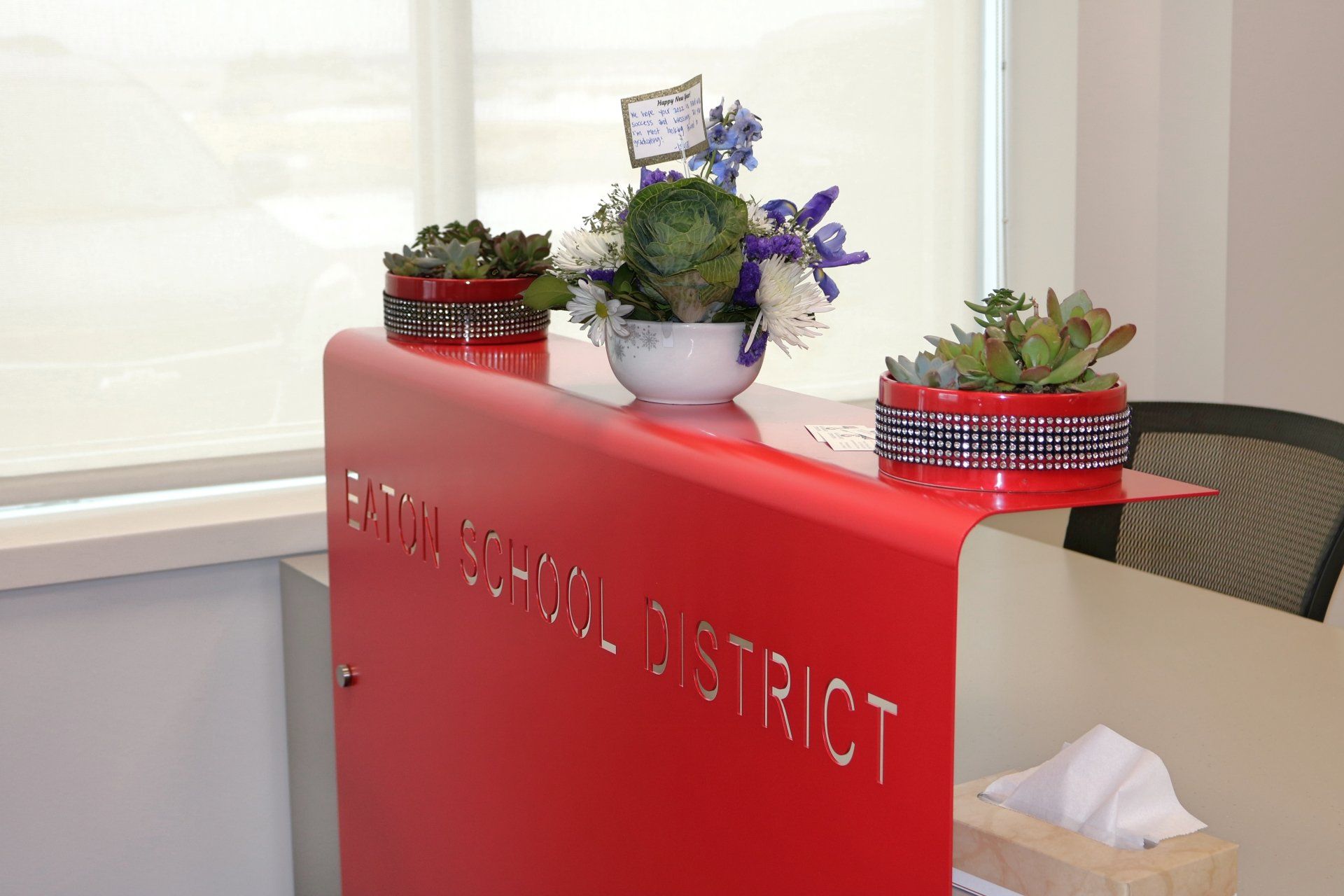 A red desk with the words