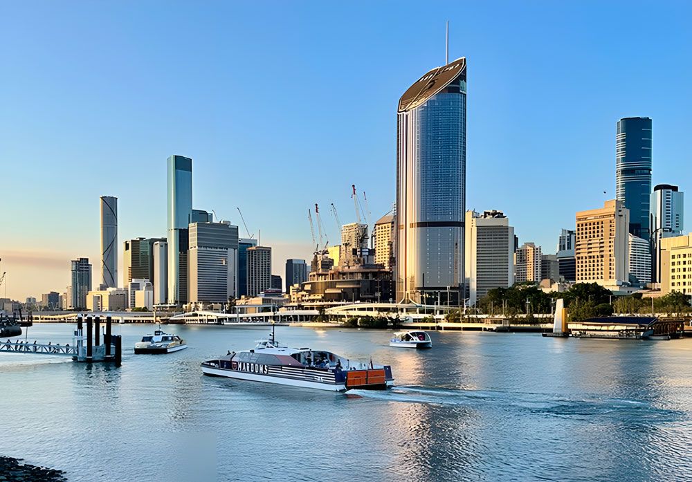 A City Skyline With A Few Boats In The Water — Munro Building Group In Brisbane, QLD