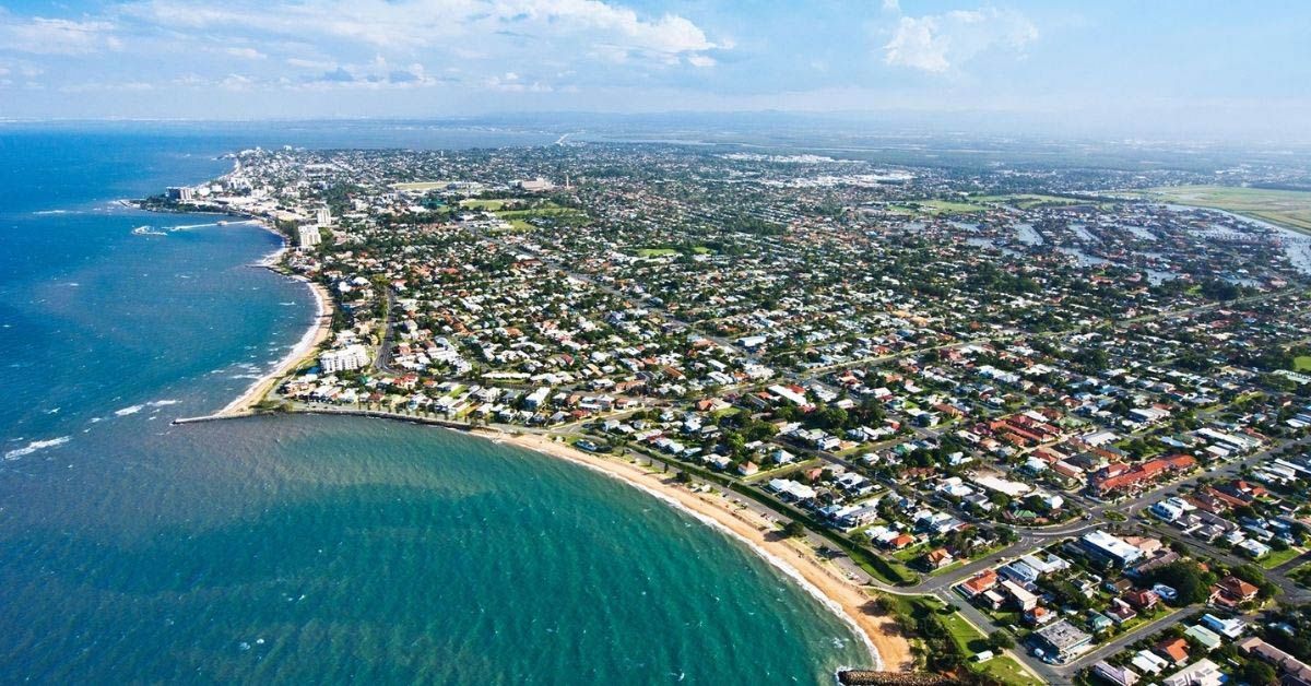 An Aerial View Of A Residential Area Next To A Body Of Water — Munro Building Group In Caboolture, QLD