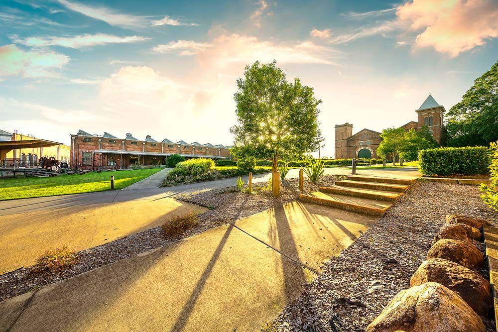 A Brick Building With Stairs Leading Up To It — Munro Building Group In Ipswich, QLD