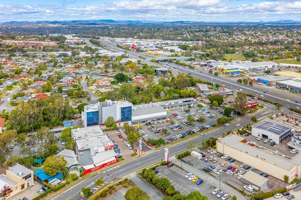 An Aerial View Of A City With A Large Car Park In The Foreground — Munro Building Group In Springwood, QLD