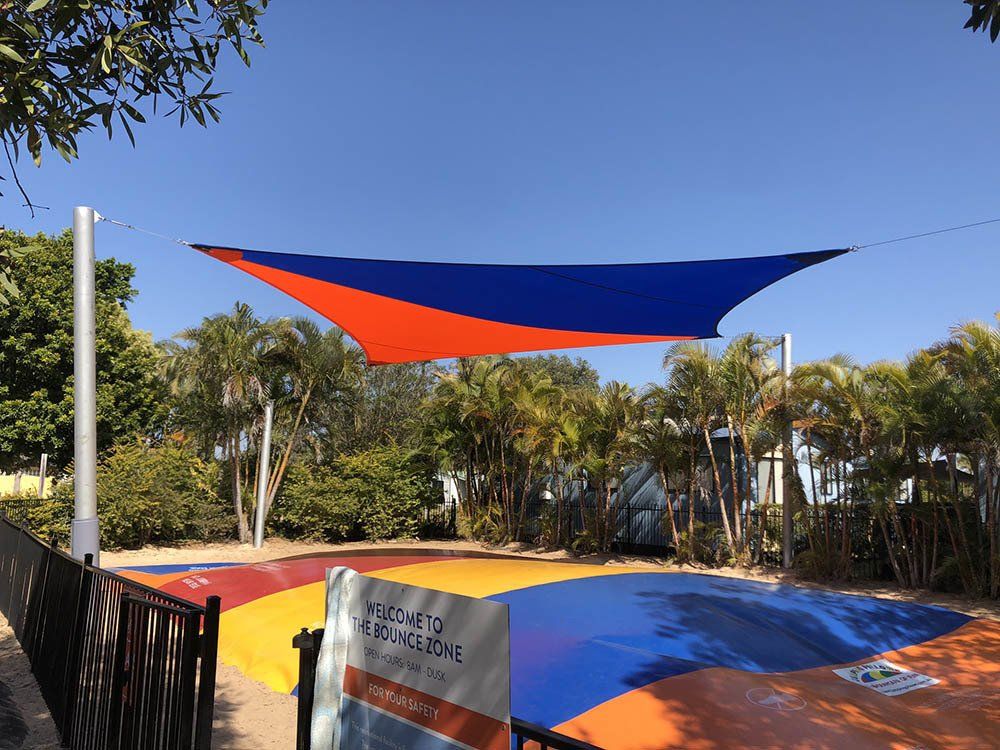 Two Color Shade Sail In A Trampoline — Shade Sail Installations in Tweed Heads, NSW
