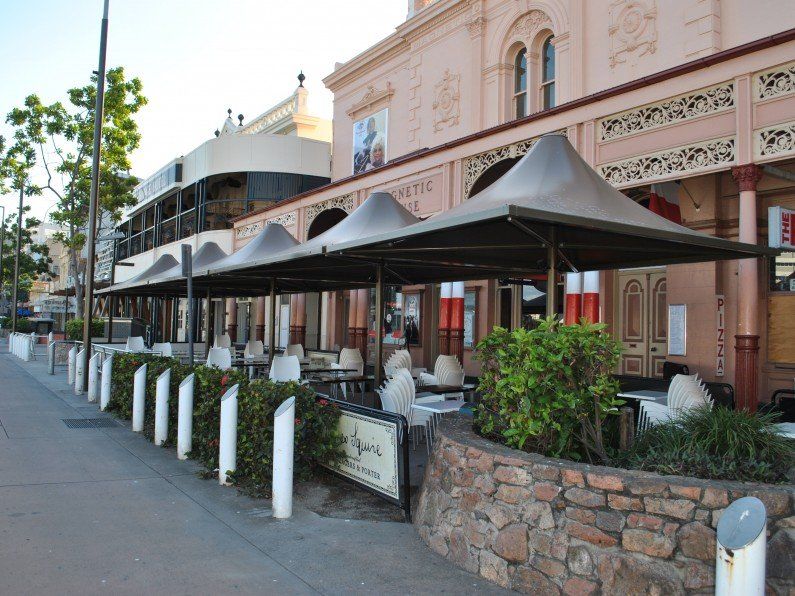 Black umbrellas outside restaurant — Shade Sail Installations in Tweed Heads, NSW