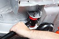 a person is working on the underside of a car