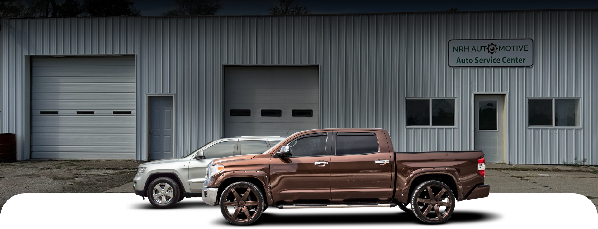 Two trucks are parked in front of a building with a phone number on it | NRH Automotive