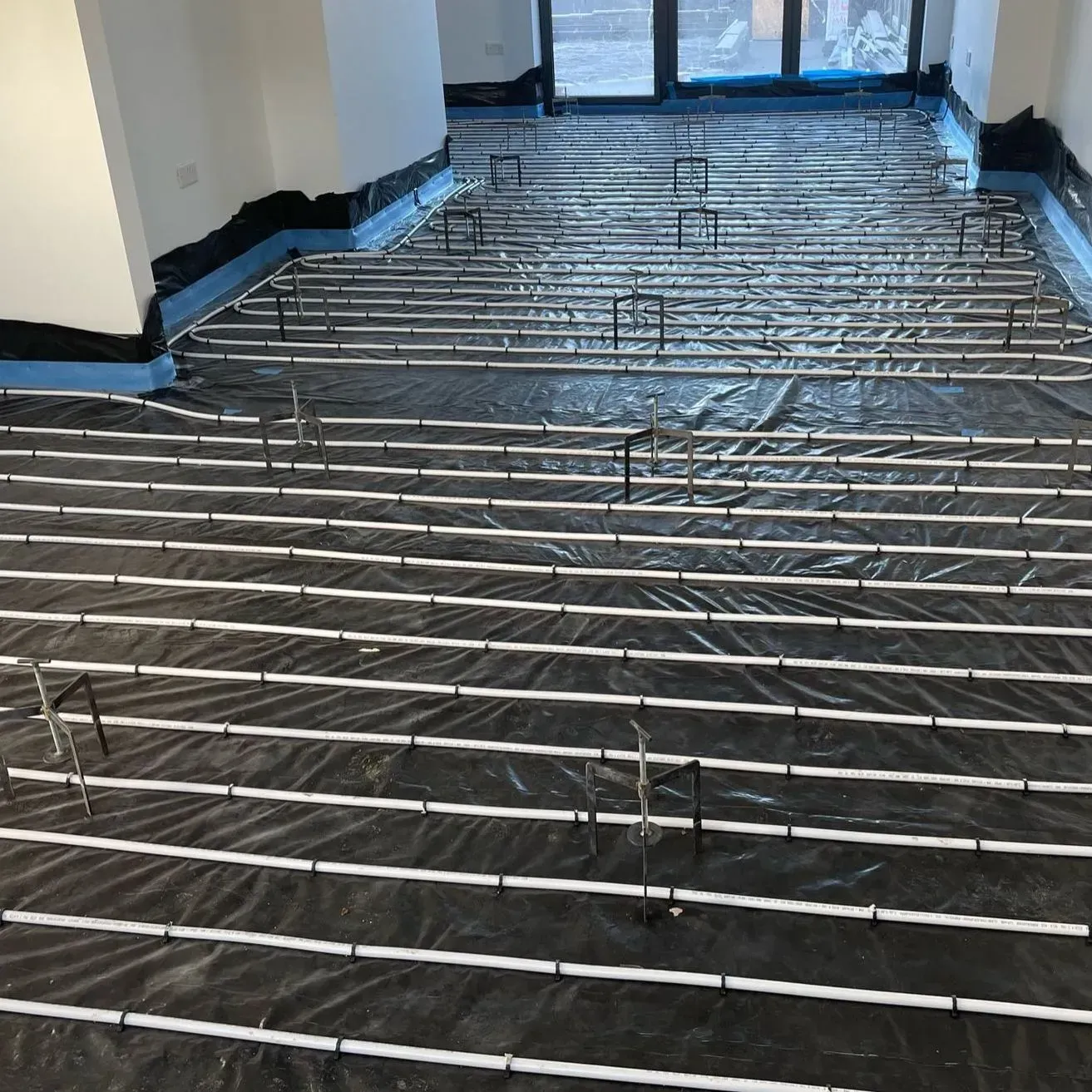 Room with underfloor heating system installed, ready for delivery of liquid screed flooring.