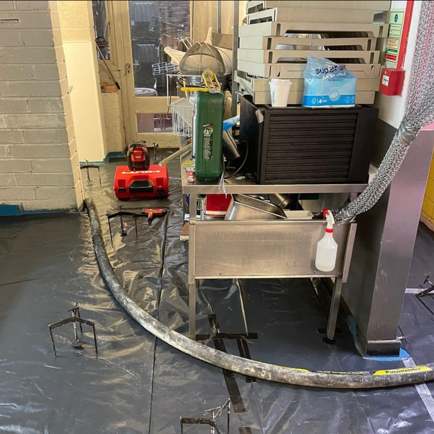 Pumping liquid screed into an industrial installation.