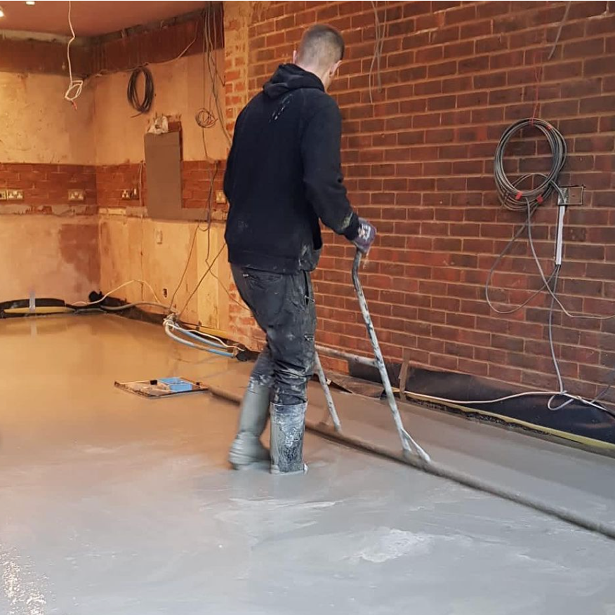 One of our team levelling a newly screeded floor.