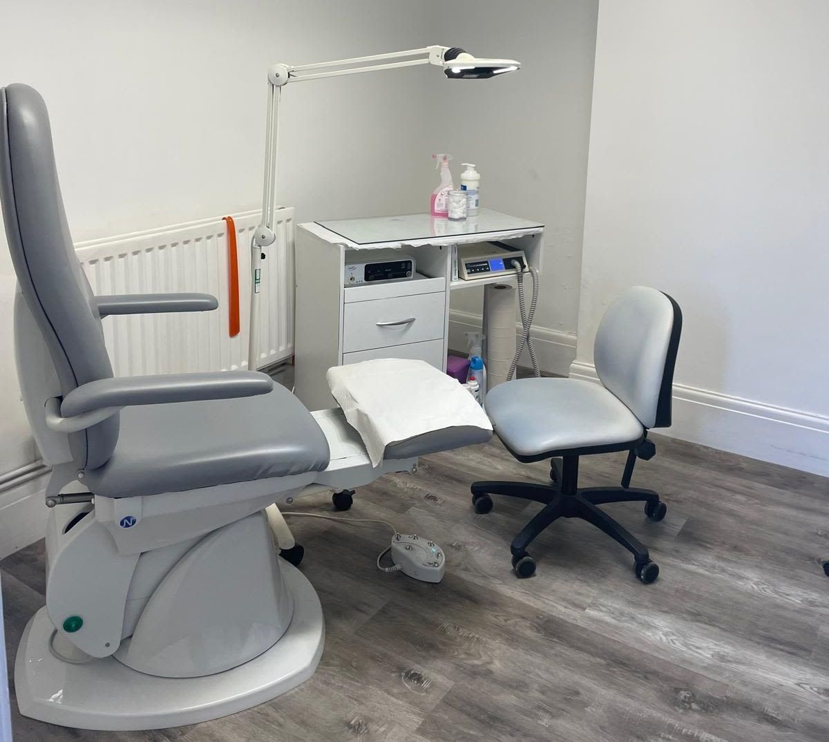 Toetal footcare Podiatrists, Cardiff & Pontypridd There is a chair and a desk in the room.