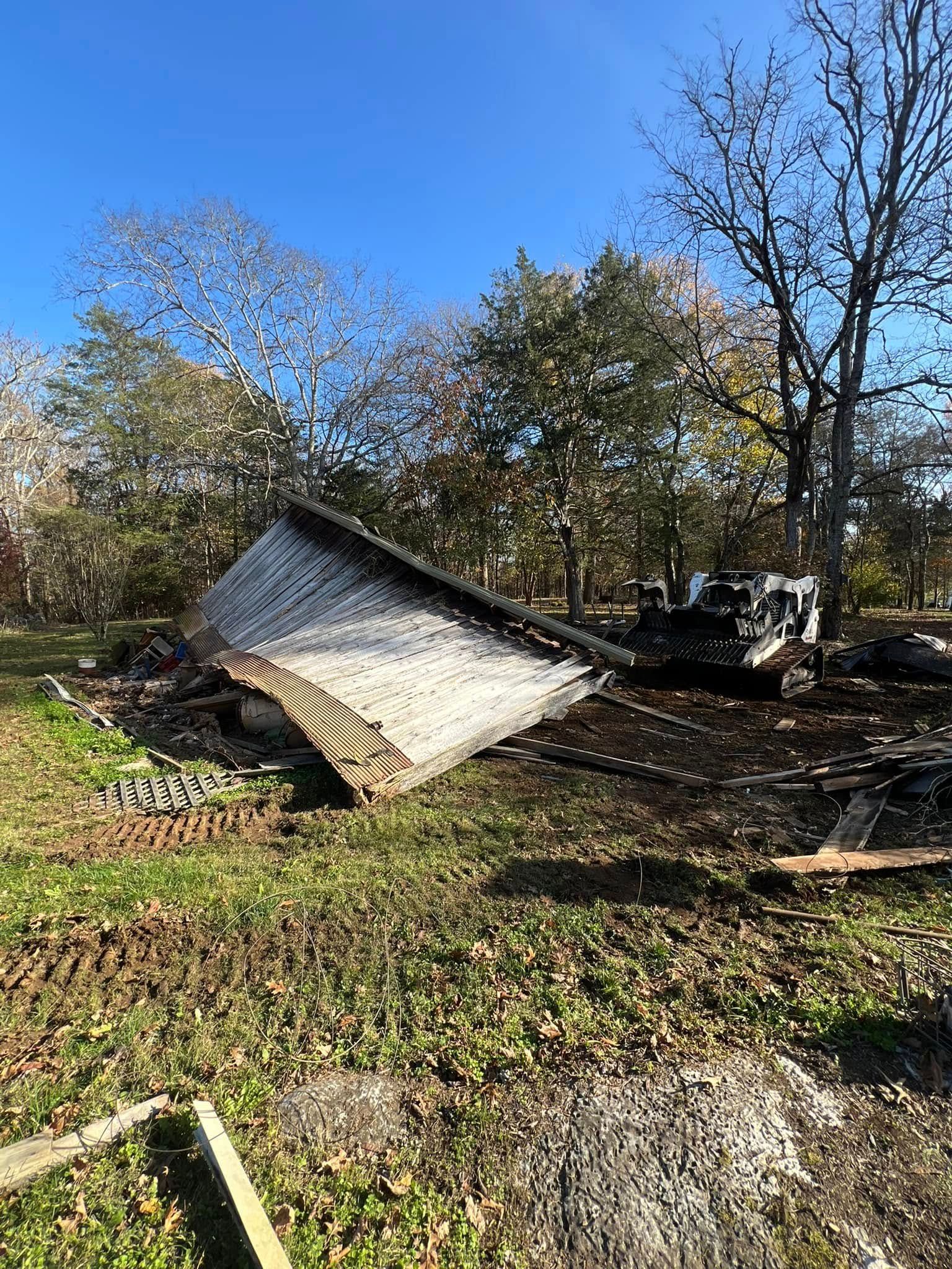 A large piece of wood is laying on the ground in a field.