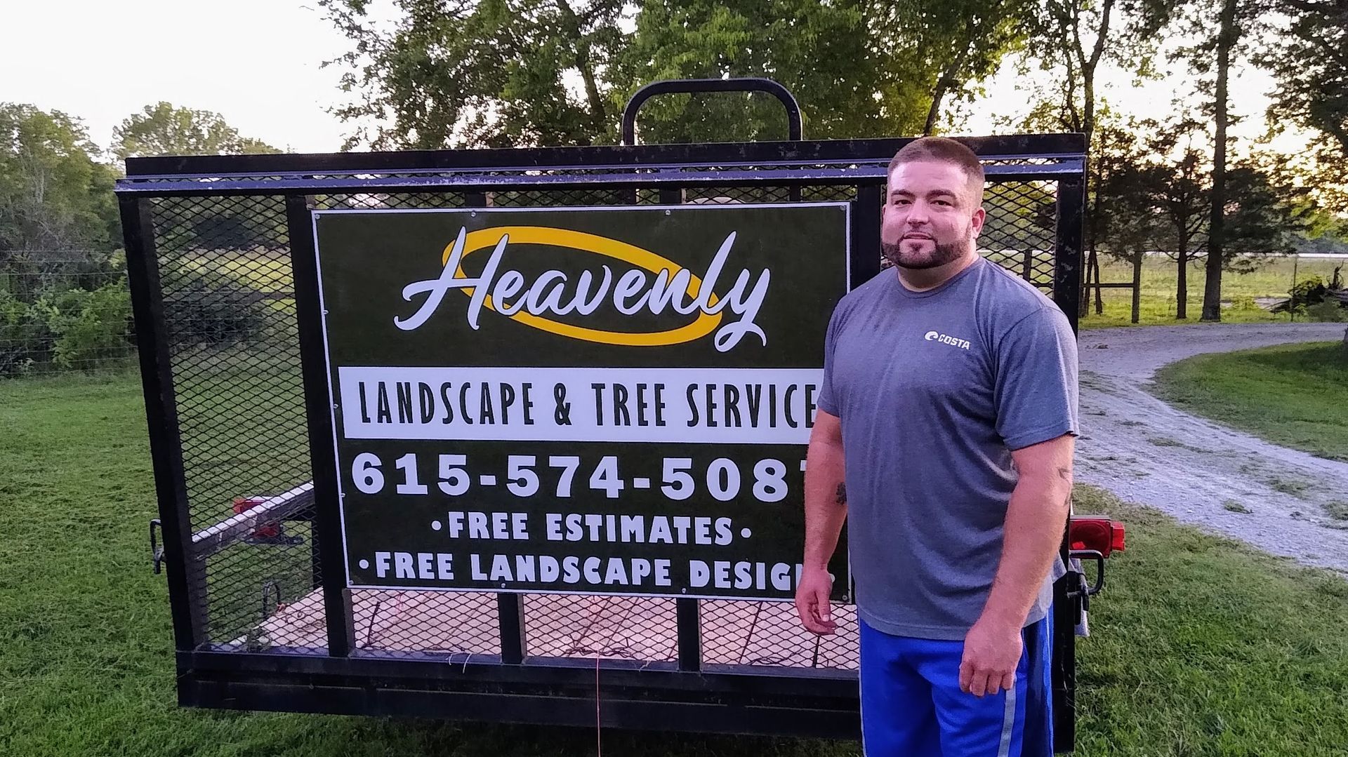 A man is standing in front of a sign for heavenly landscape and tree service.