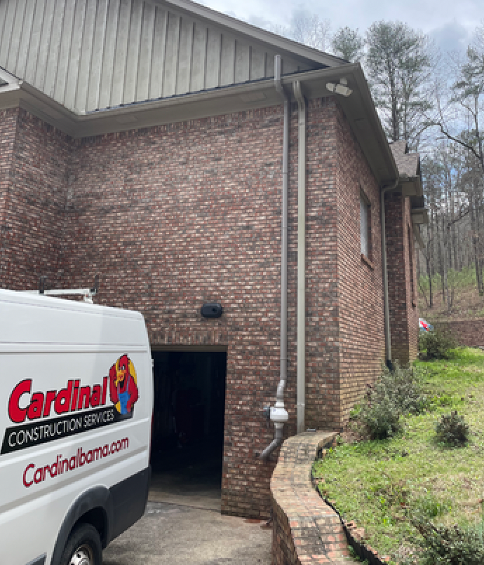 A White Van Is Parked in Front of A Brick Building | Birmingham, AL | Cardinal Construction