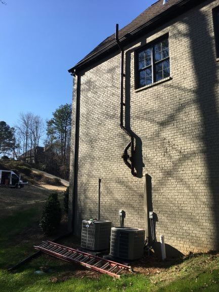 A Ladder Is Sitting on The Side of A Brick Building | Birmingham, AL | Cardinal Construction
