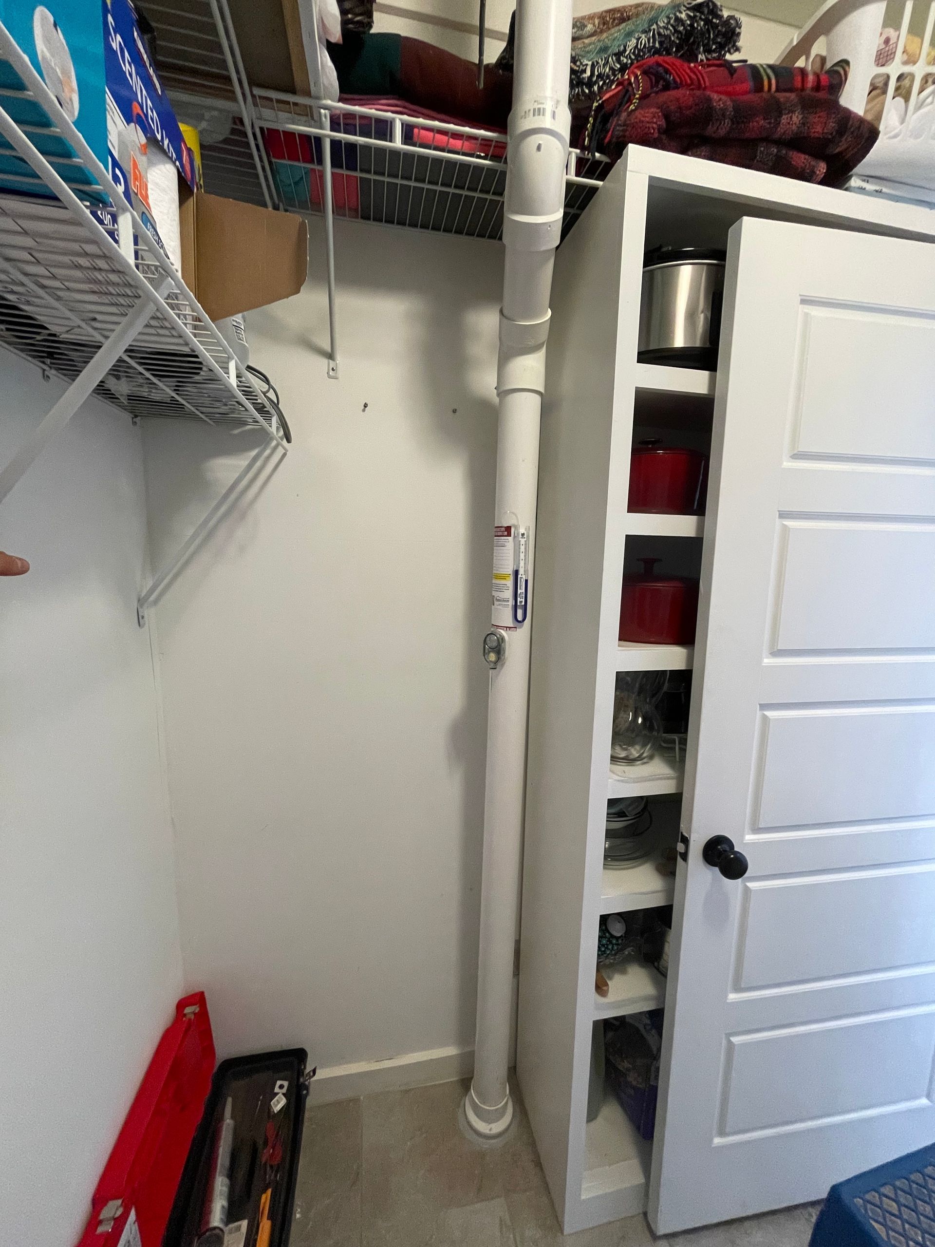 A Closet with A Door Open and A Pipe Coming out Of It | Birmingham, AL | Cardinal Construction