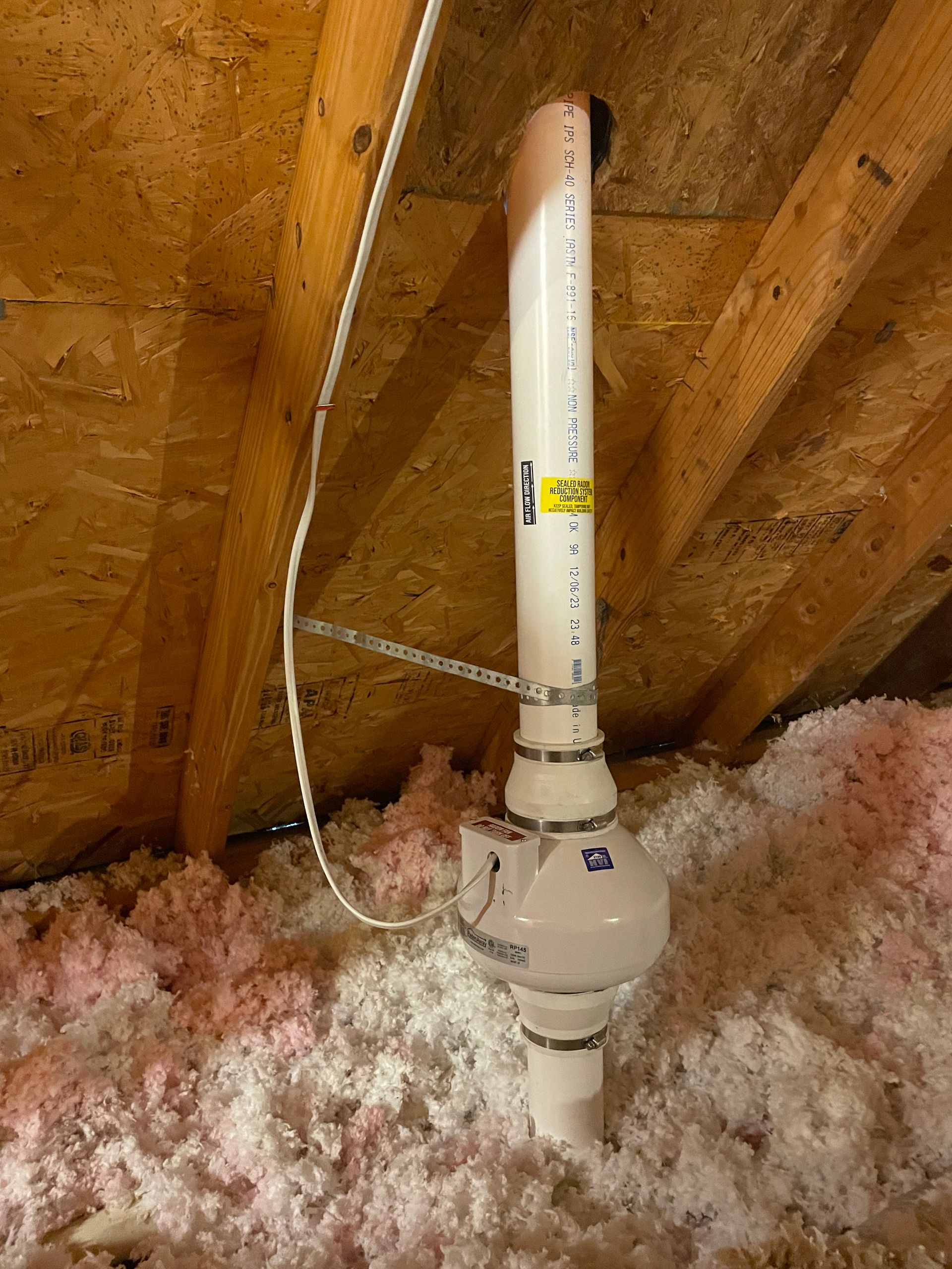 A White Pipe Is Hanging from The Ceiling of An Attic | Birmingham, AL | Cardinal Construction