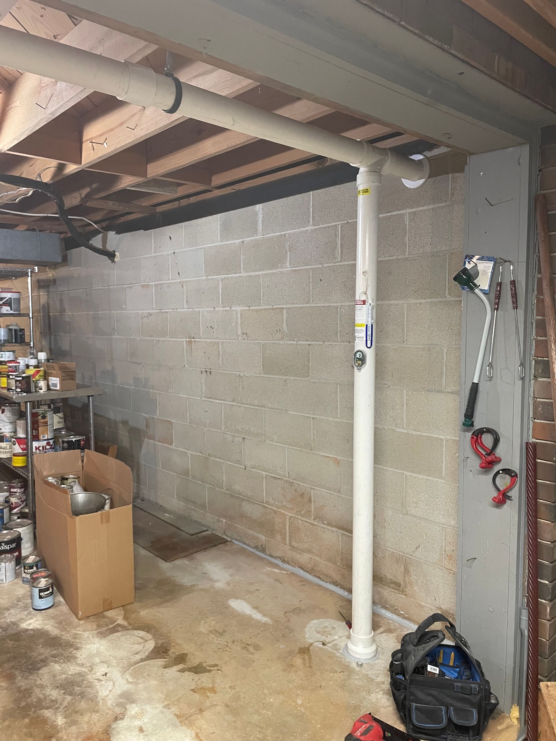 A Basement with A Brick Wall and A White Pipe | Birmingham, AL | Cardinal Construction