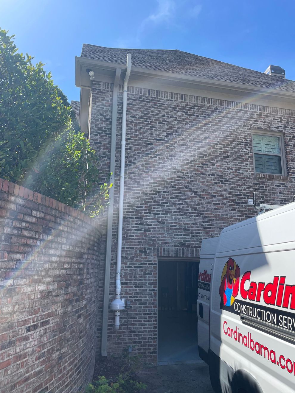 A White Van Is Parked in Front of A Brick Building | Birmingham, AL | Cardinal Construction