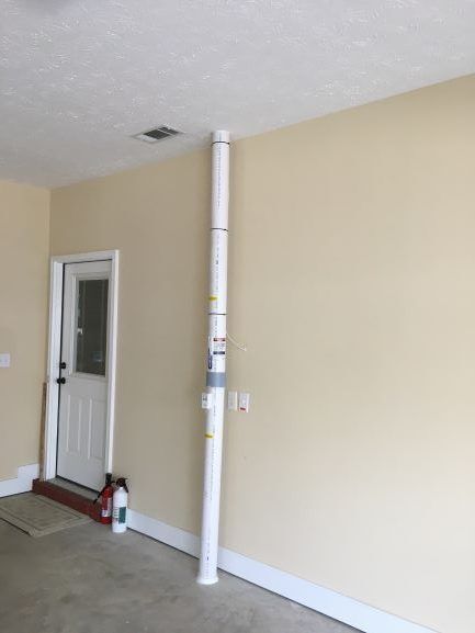A White Pole Is Sitting in A Garage Next to A Door | Birmingham, AL | Cardinal Construction
