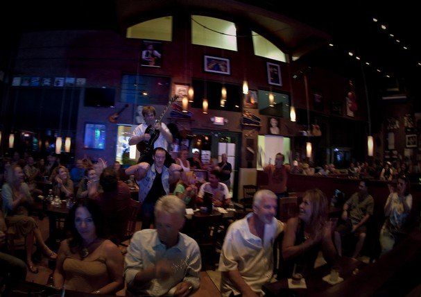 A group of people are sitting at tables in a restaurant