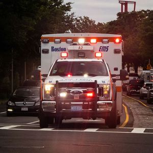 A boston ems ambulance is driving down the street