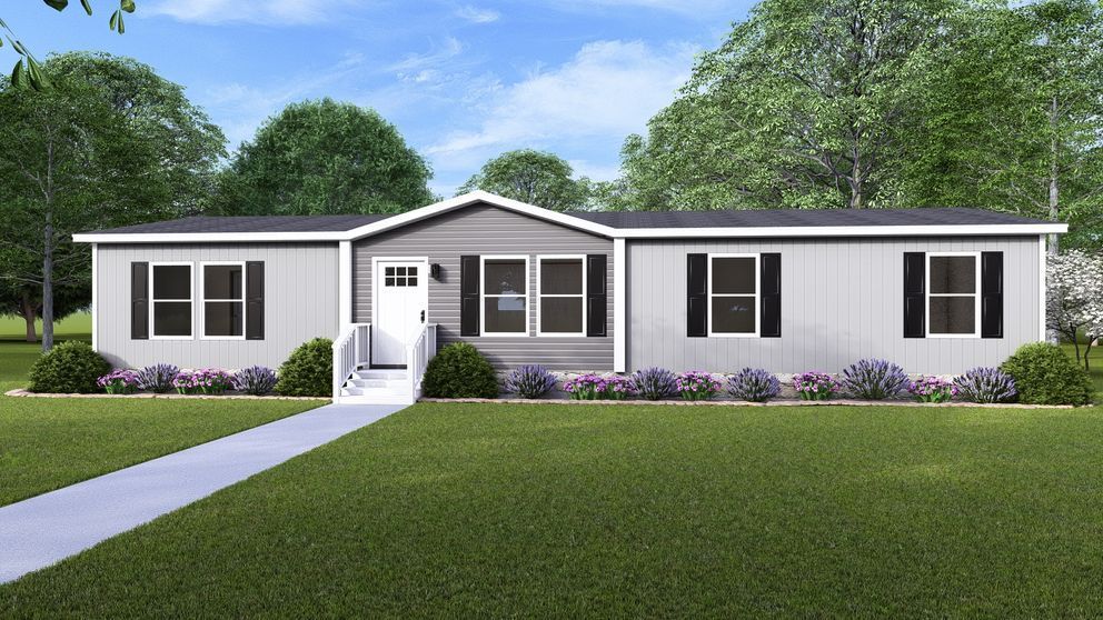 Gray manufactured home with black shutters, white door, and landscaped yard.