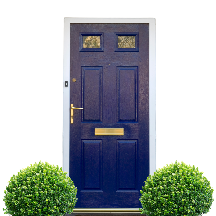 Blue front door with brass hardware, framed in white, two green bushes at the bottom.