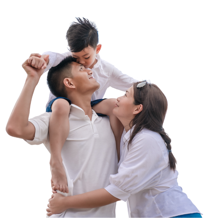 A family of three: father carrying son on shoulders, son kissing father, mother looking up, all in white shirts.