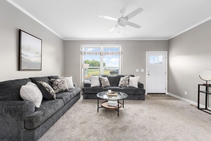 Living room with gray sofa, coffee table, and white door.